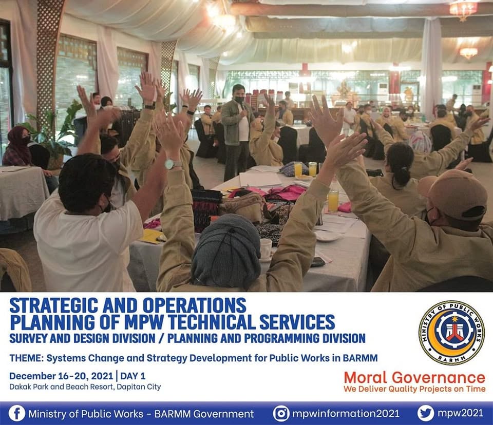 Participants raise their hands during the MPW technical services planning workshop.